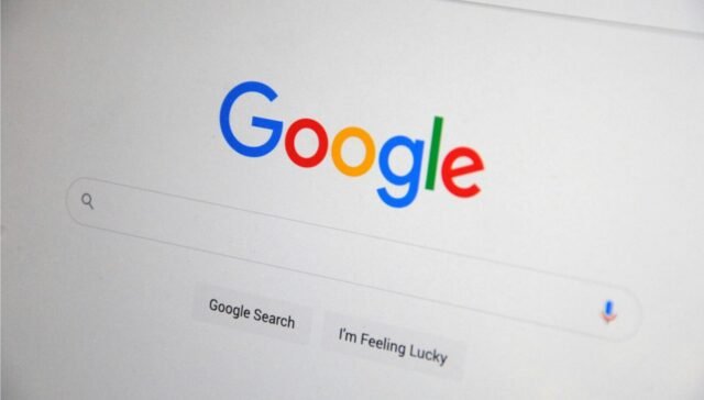 Seseorang sedang menganalisis grafik kenaikan trafik organik di halaman pertama pencarian Google pada layar monitor.